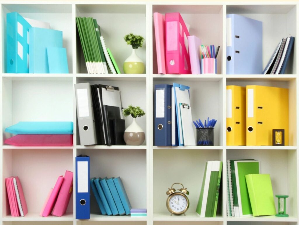 Shelf of office supplies organized by color